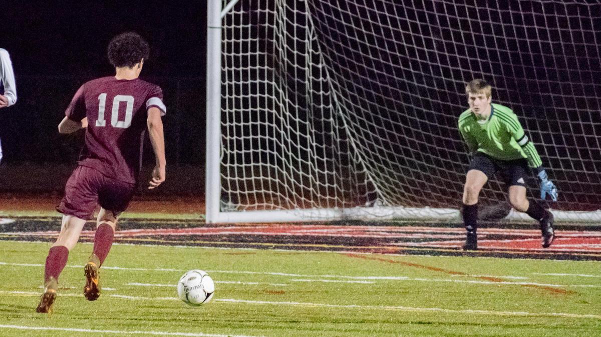Reed Pro of State College has one man to beat but went wide on his shot. State College boys soccer takes the District 6 AAAA title over Altoona with a 5-1 win at Saint Francis on Monday, oct. 29, 2018.