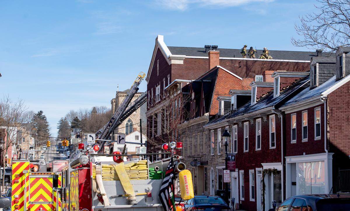 Firefighters work on the roof of the former Cadillac Building in downtown Bellefonte on Wednesday after reports of a fire in the attic.