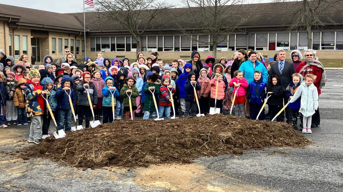 Students from Liberty Curtin Elementary help to break ground during the first day of construction on the new Liberty Curtin Elementary School