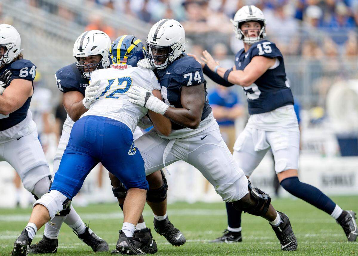 Penn State offensive lineman Olumuyiwa Fashanu blocks Delaware’s Chase McGowan for Drew Allar to make a pass during the game on Saturday, Sept. 9, 2023.