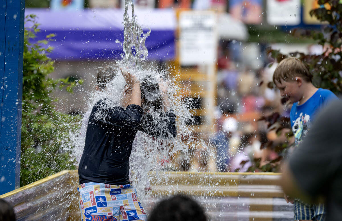 A youngster gets dumped on by the buckets during Children and Youth Day at the Central Pennsylvania Festival of the Arts on Wednesday, July 8, 2026.