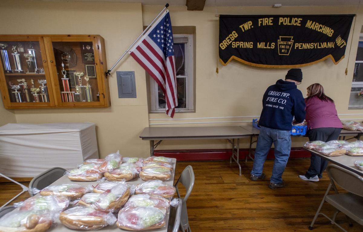Gregg Township Fire Department volunteers organize stacks of hoagies they made for their hoagie sale on Jan. 31, 2019.