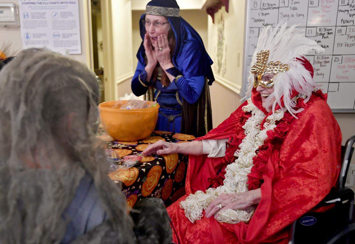 Betty Lazar, 94, laughs as she admires trick-or-treaters’ costumes at Eagle Valley Personal Home Care in 2017.