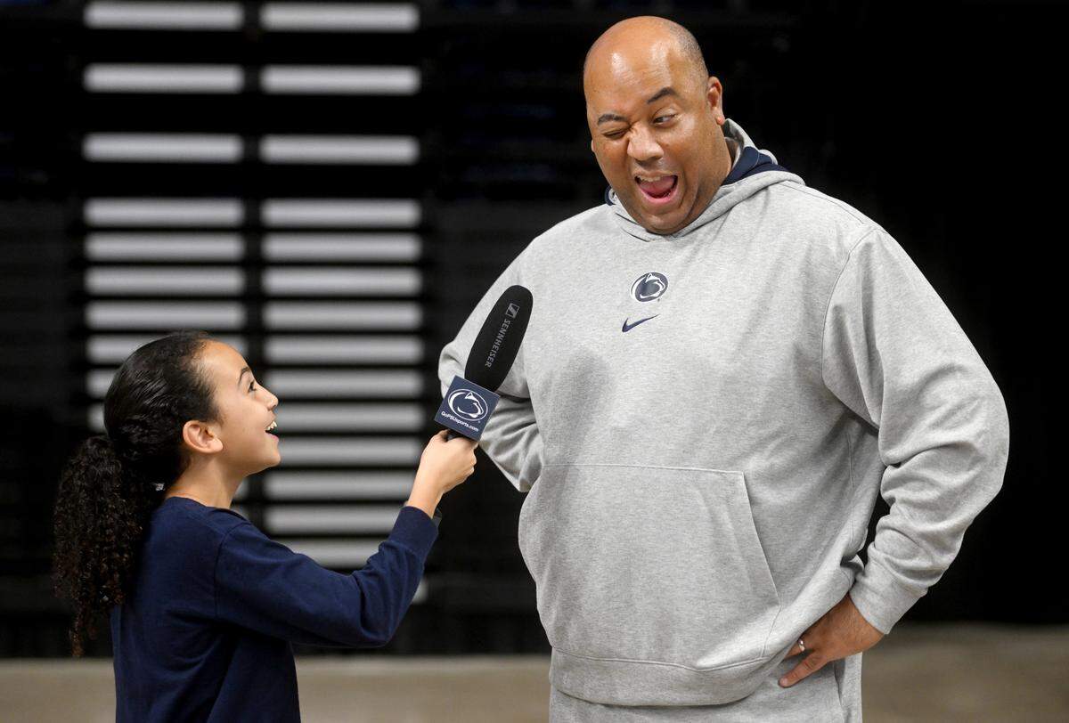 Penn State men’s basketball coach Micah Shrewsberry winks at his youngest daughter Grace as she interviews with fun questions him during media day on Tuesday, Oct. 25, 2022.