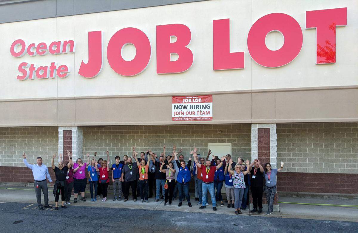 Ocean State Job Lot employees post outside of the new location at 2222 E. College Ave.