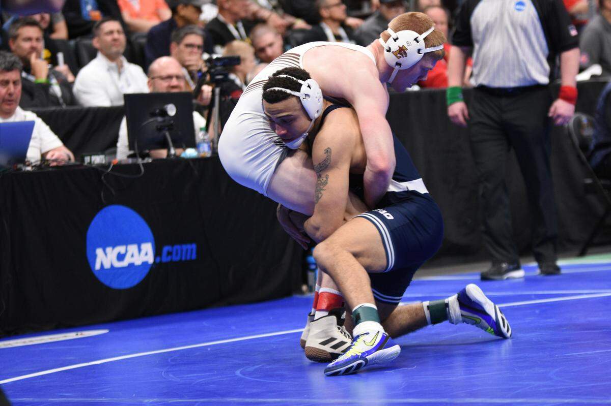 Penn State’s Aaron Brooks looks to finish off a takedown on Lehigh’s AJ Burkhart in their 184-pound first round match of the NCAA Championships on Thursday, March 17, 2022 at Little Caesar’s Arena in Detroit. Brooks topped Burkhart, 21-7.