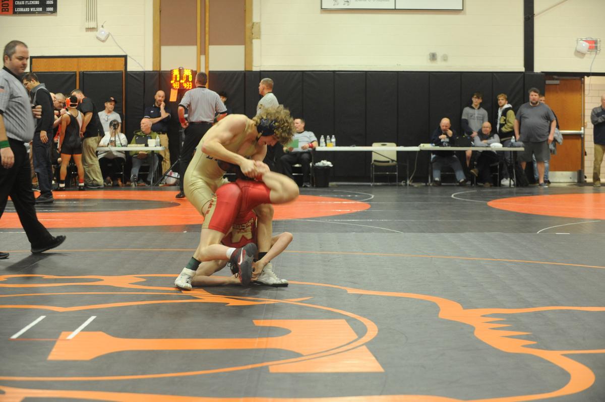 Bald Eagle Area’s Lucas Fye scrambles with Bishop McCort’s Jax Forrest in their 127-pound finals of the Laurel Highlands Athletic Conference tournament on Saturday at Tyrone. Forrest beat Fye, 19-4 in 2:41.