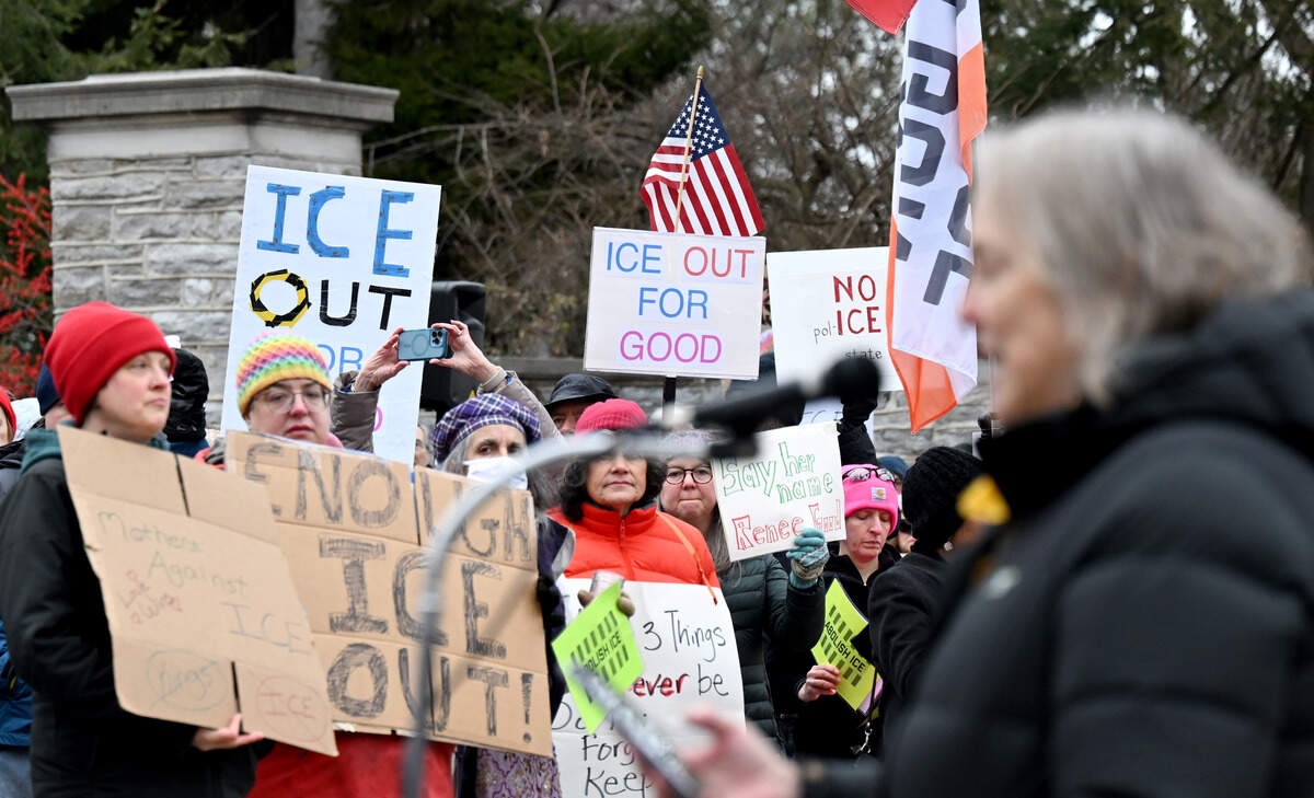 Community members hold signs to protest ICE as Rev. Tracy Sprowls addresses the crowd at the Allen Street Gates on Saturday, Jan. 10, 2026. Protests were held around the country after the killing of Renee Nicole Good.