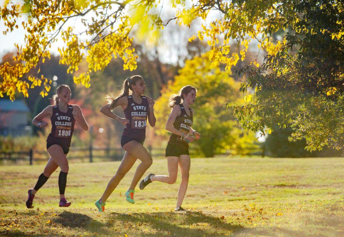 State College runners Karsyn Kane, Marlee Kwanasnica and Jordan Reed lead the race under a colorful tree during cross country meet against Central Dauphin East on Tuesday, Oct. 13, 2020 at Circleville Park.  