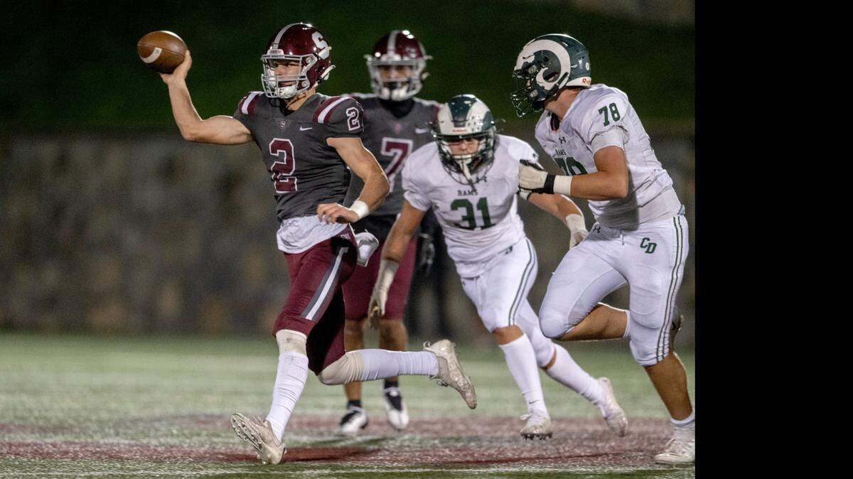 State College’s Finn Furmanek makes a running pass while being pressured by Central Dauphin defenders during the game on Friday, Sept. 23, 2022 at Memorial Field.