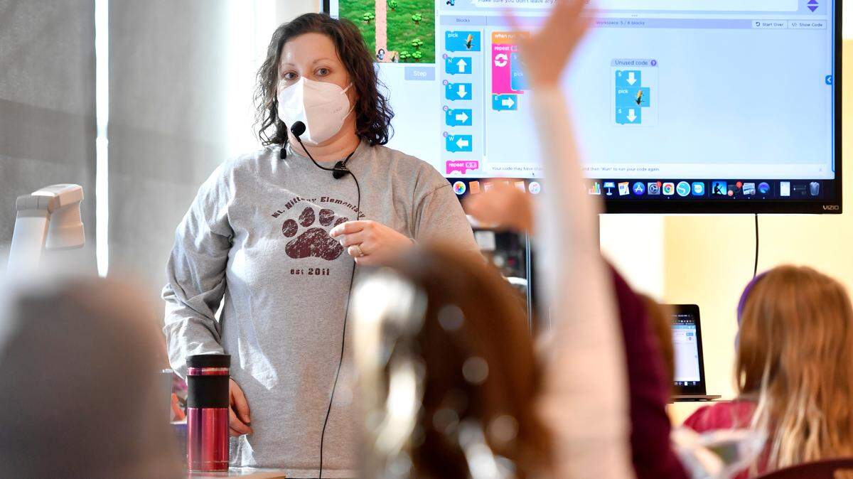 First graders raise their hands to answer a question from Tara Pollick during a STEM class at Mount Nittany Elementary on Friday.