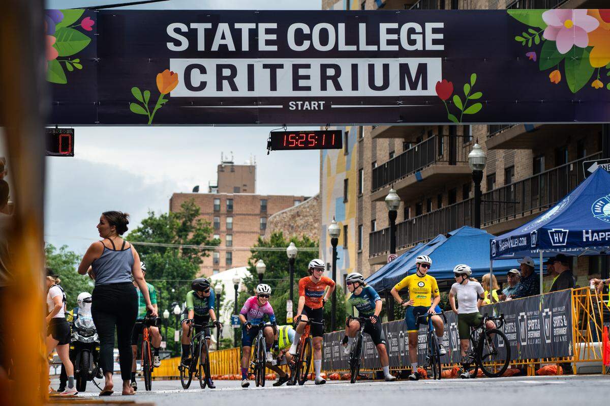 Participants of the Women’s Cat 1, Cat 2 and Cat 3 cycling race wait at the start line during the State College Criterium on Saturday, July 26, 2025 in State College, Pa.