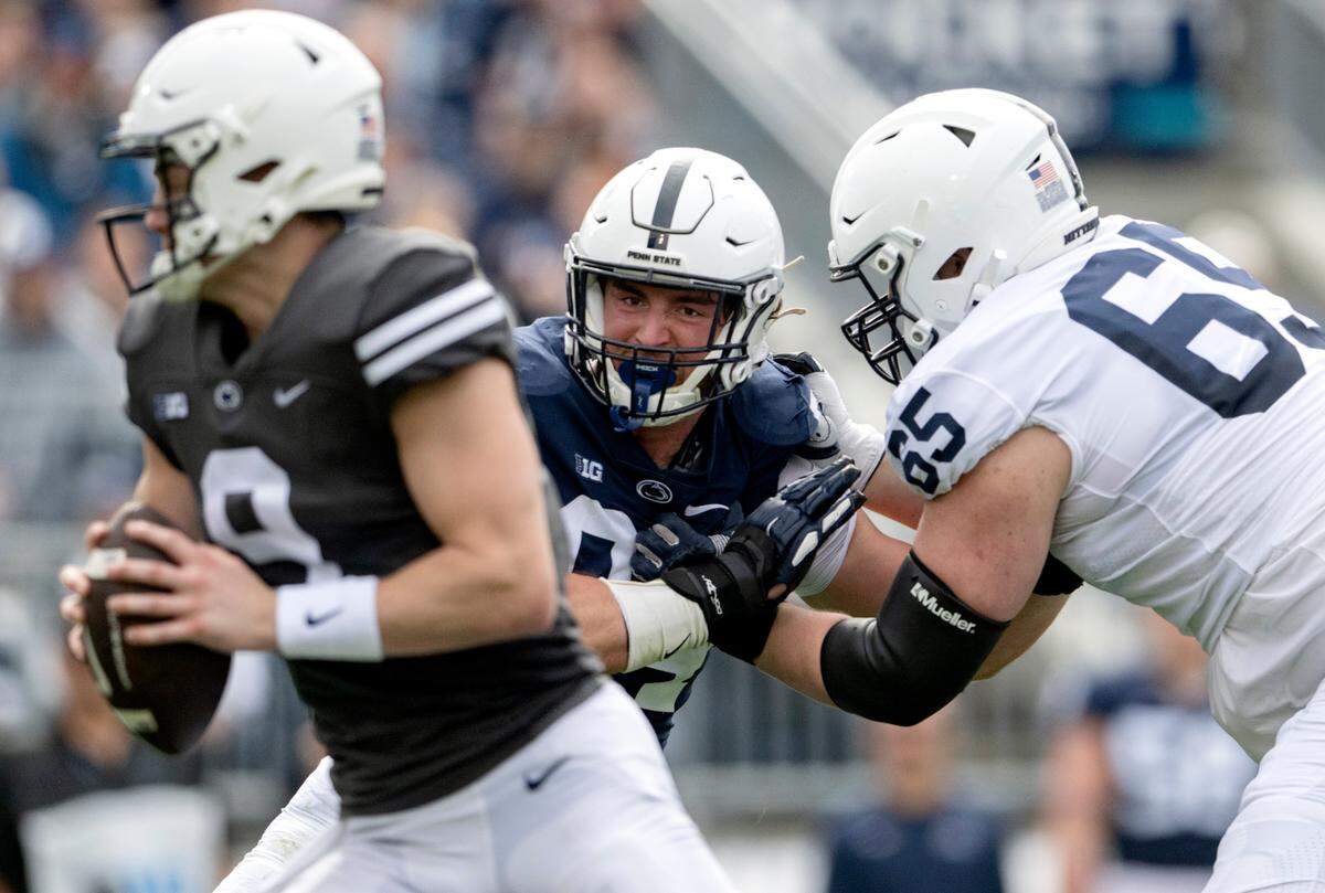 Defensive end Jake Wilson pushes around offensive lineman Jim Fitzgerald to pressure the quarterback during the Penn State Blue-White game on Saturday, April 15, 2023.