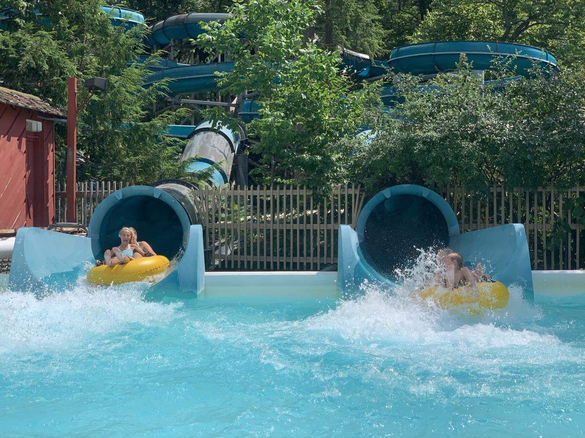 Knoebels patrons plunge into a pool from a water slide.