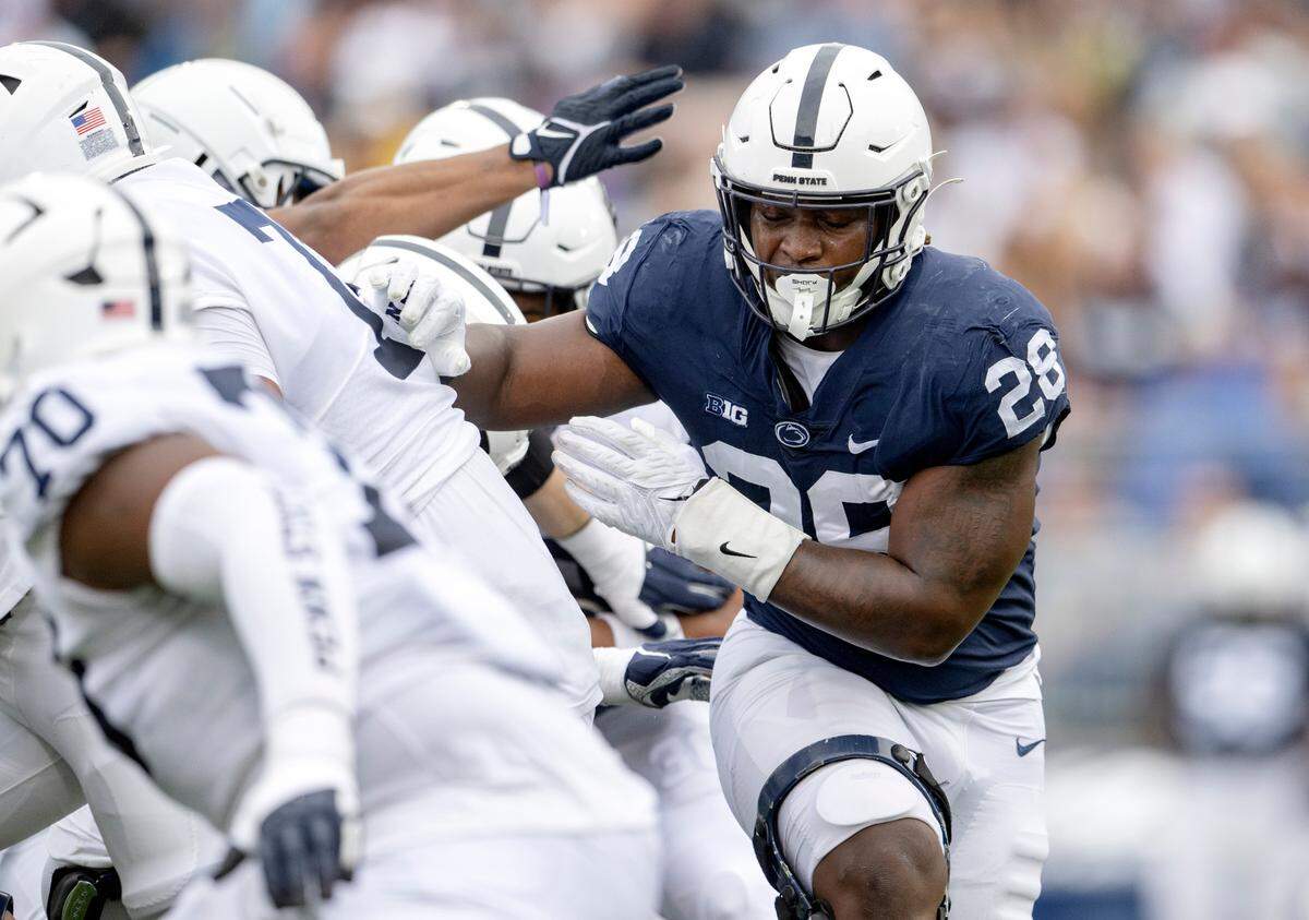 Defensive end Adisa Isaac cuts through the line during the Penn State Blue-White game on Saturday, April 15, 2023.