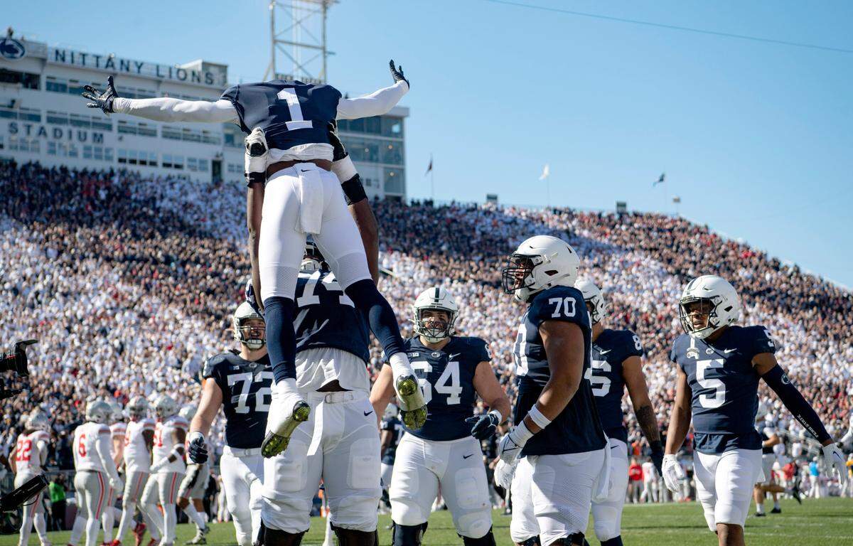 Penn State offensive lineman Olumuyiwa Fashanu lifts up wide receiver KeAndre Lambert-Smith after his touchdown during the game against Ohio State on Saturday, Oct. 29, 2022.