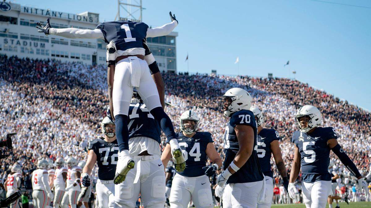Penn State offensive lineman Olumuyiwa Fashanu lifts up wide receiver KeAndre Lambert-Smith after his touchdown during the game against Ohio State on Saturday, Oct. 29, 2022.