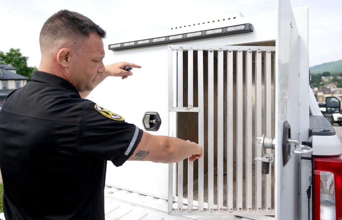 Centre County humane officer Mark Rusnak shows the temperature controlled kennels that are part of his truck on Monday June 30, 2025.