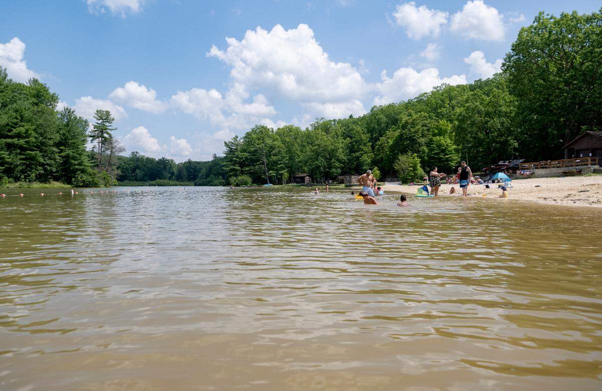 Families gather at Whipple Dam State Park to swim and stay cool on Wednesday, July 20, 2022.