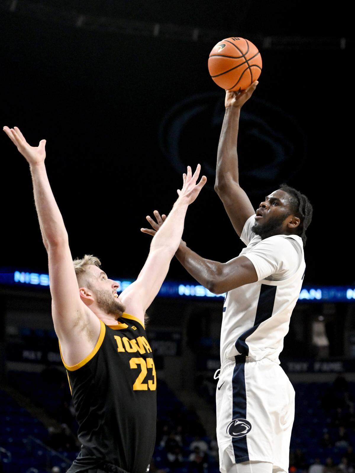 Penn State’s Qudus Wahab goes in for a basket over Iowa’s Ben Krikke during the game on Thursday, Feb. 8, 2024. Penn State won, 89-79.