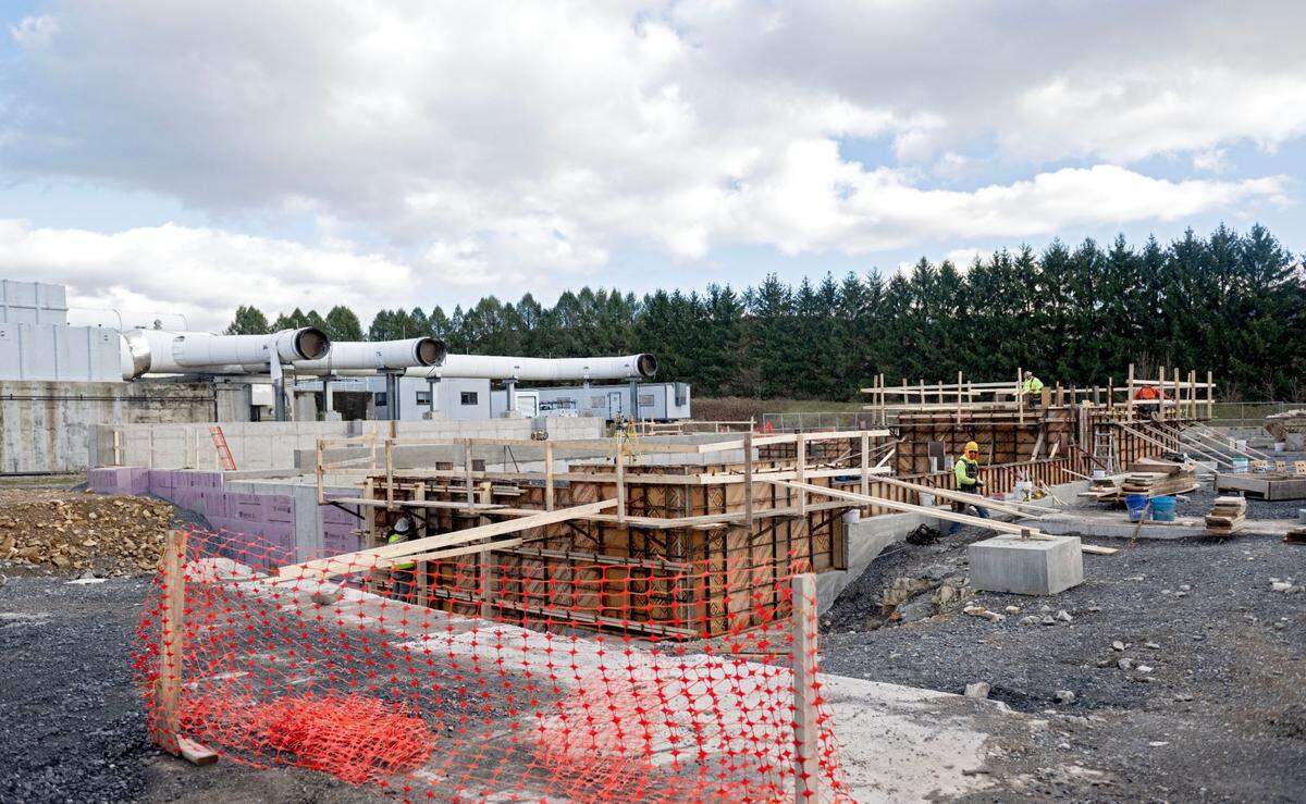 Construction crews work on Nov. 26 at the waste receiving building that is part of the biosolids project at the University Area Joint Authority.