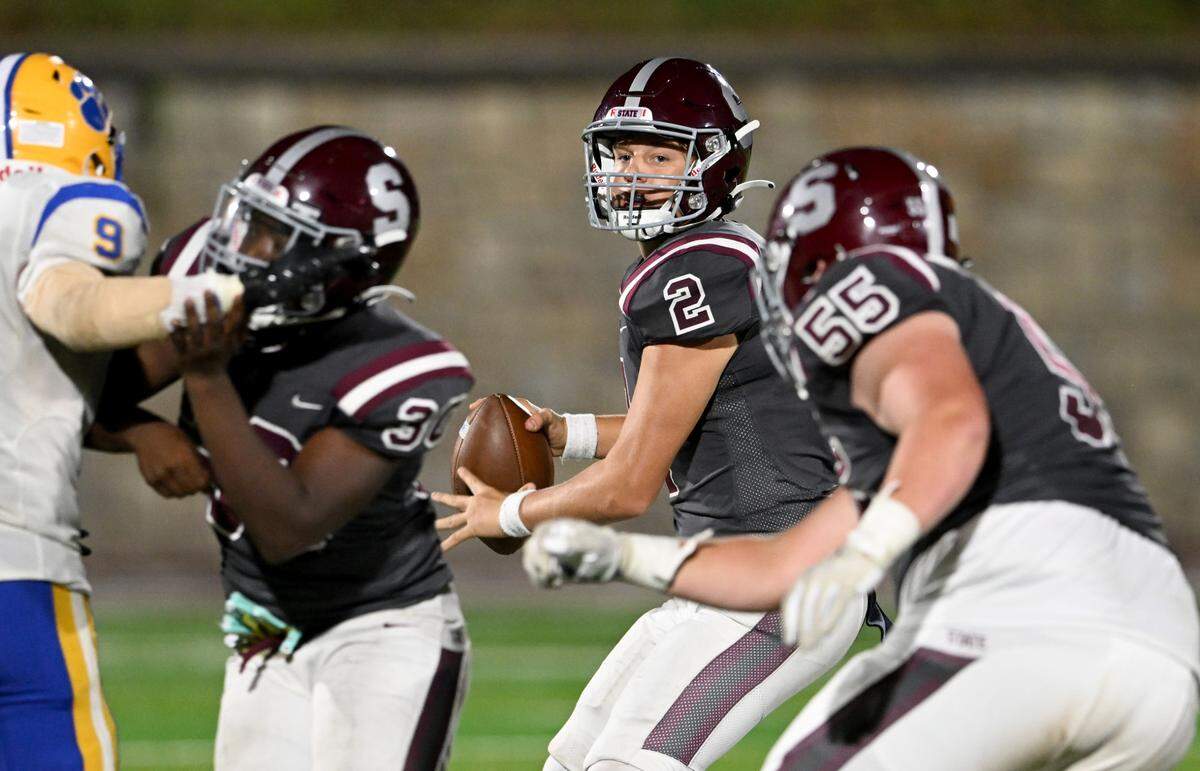 State College’s Eddie Corkery drops back to make a pass during the game against Downingtown East on Friday, Sept. 1, 2023.