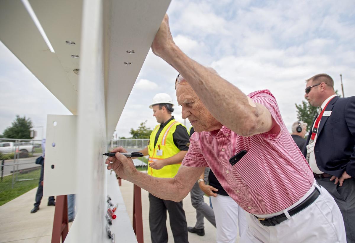 Andy Charney signs his name on the final steel beam for the new cardiovascular pavilion at Mount Nittany Medical Center before it was raised and placed during a ceremony on Friday, August 10, 2018.  Andy Charney and his wife Marilyn were financial donors for the new center.   