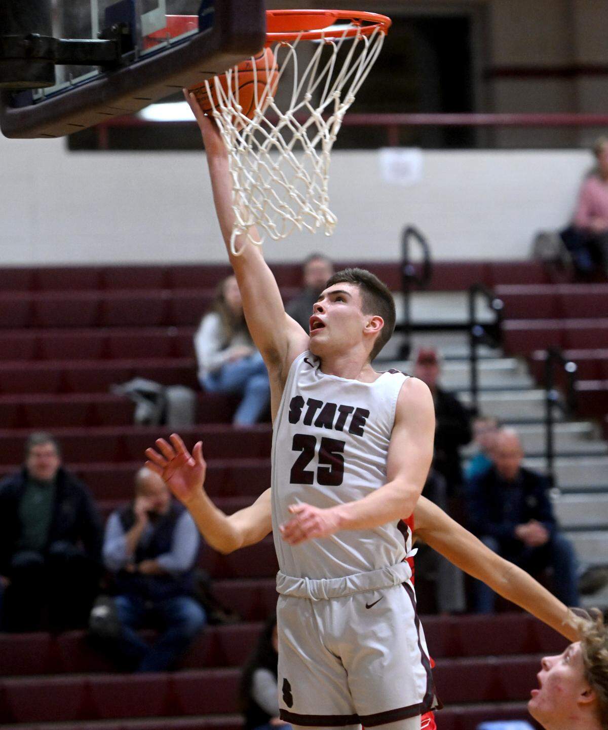State College’s Isaac Dye goes in for a basket ahead of a Williamsport defender during the game on Thursday, Jan. 5, 2023. State College won, 64-33.