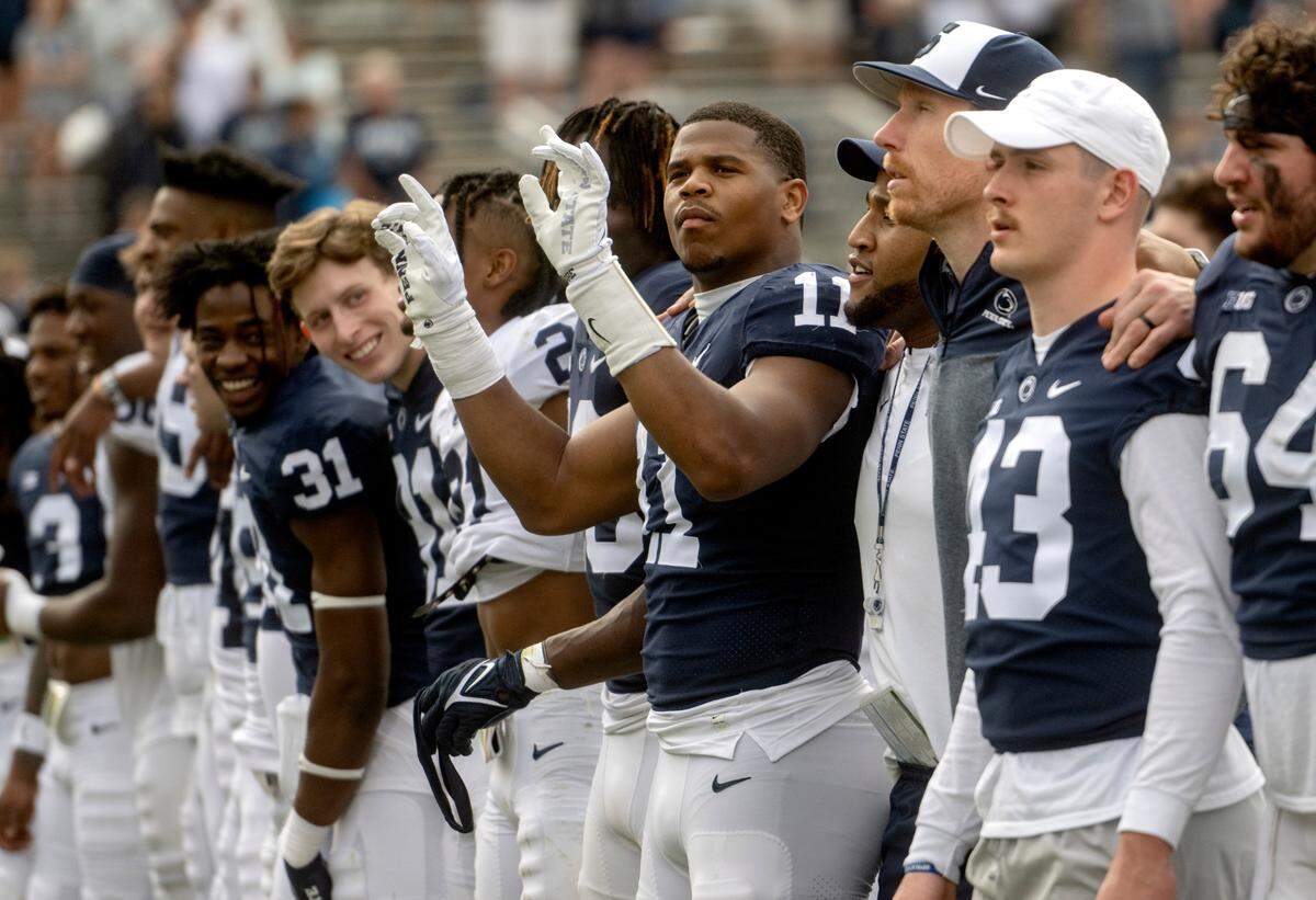 Linebacker Abdul Carter pretends to conduct as the team sings the alma mater after the Penn State Blue-White game on Saturday, April 15, 2023.