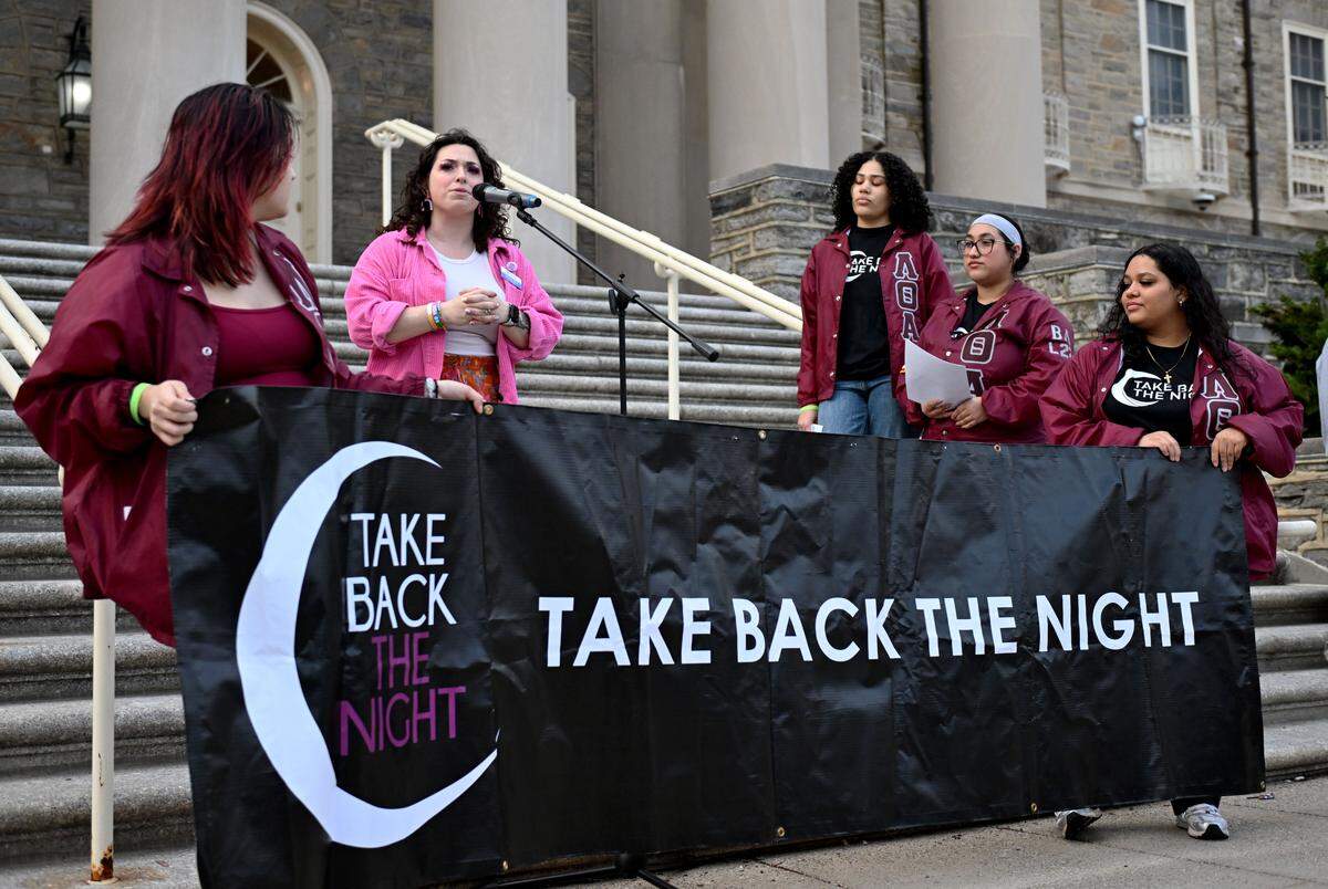 Sophia Mills, associate director of Penn State’s R-VOICE Center, talks about the resources available to students at the start of “Take Back the Night” on Wednesday, April 1, 2026 in front of Old Main. Lambda Theta Alpha hosted the event, which is part of Sexual Assault Awareness Month.