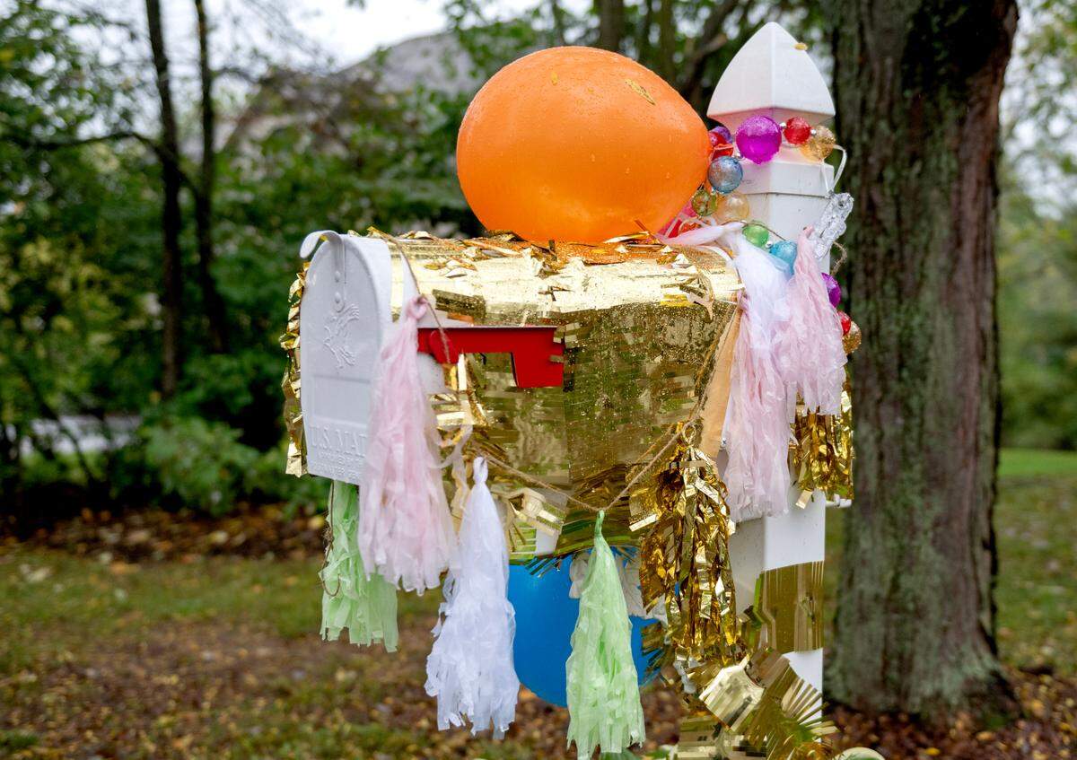 The Clover Highlands neighborhood decorated their mailboxes Monday to honor their mailman Jon Kolesar’s retirement.
