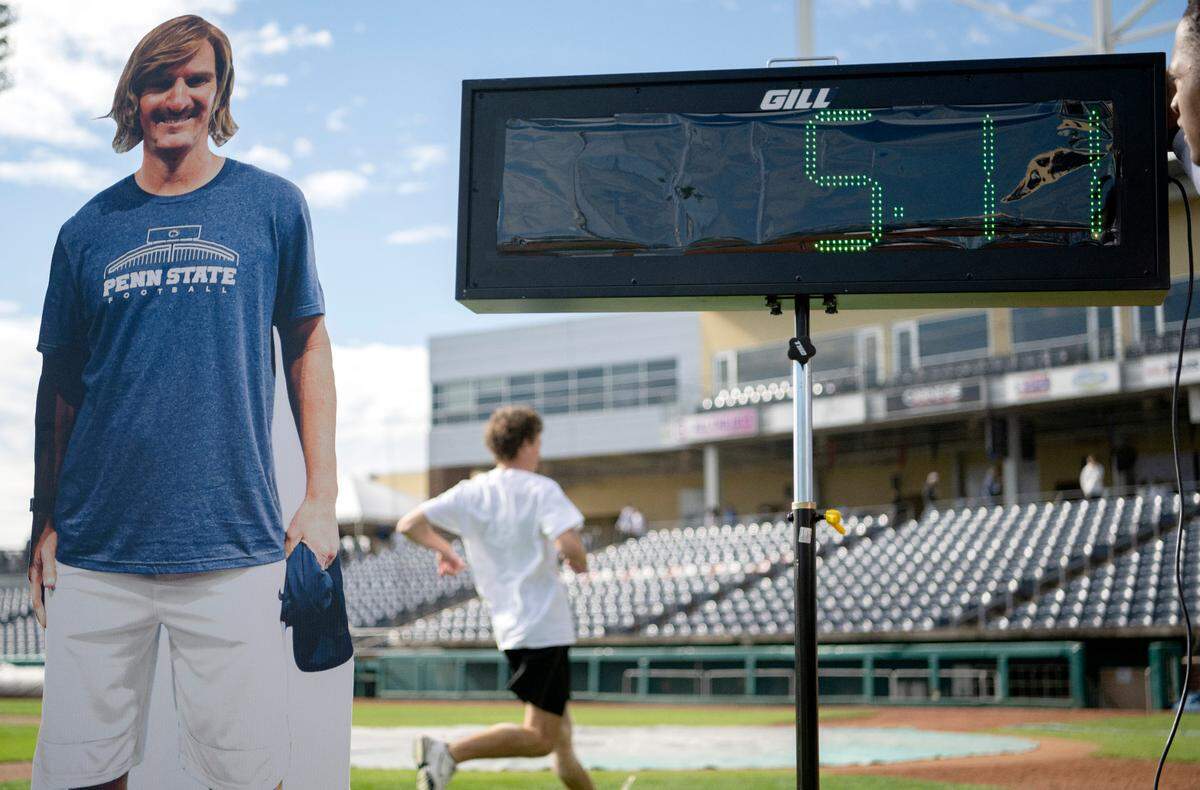 Penn State fans try to beat Chad Powers 40-yard dash time at Medlar Field before the football game on Saturday Sept. 24, 2022.