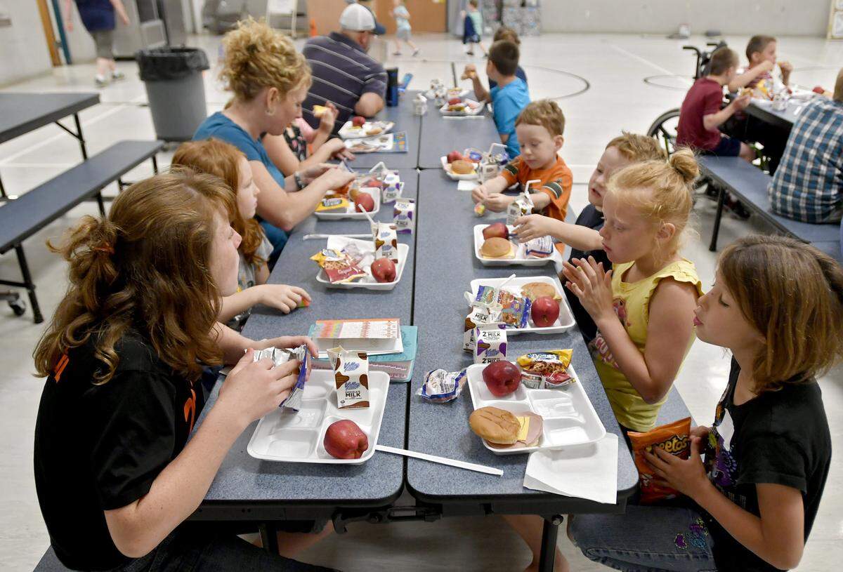 Youngsters enjoy milk, a ham and cheese sandwich, apples, carrots and a snack at Howard Elementary on Friday, June 23, 2017. The YMCA summer lunch program offers free lunches to youngsters throughout the community.
