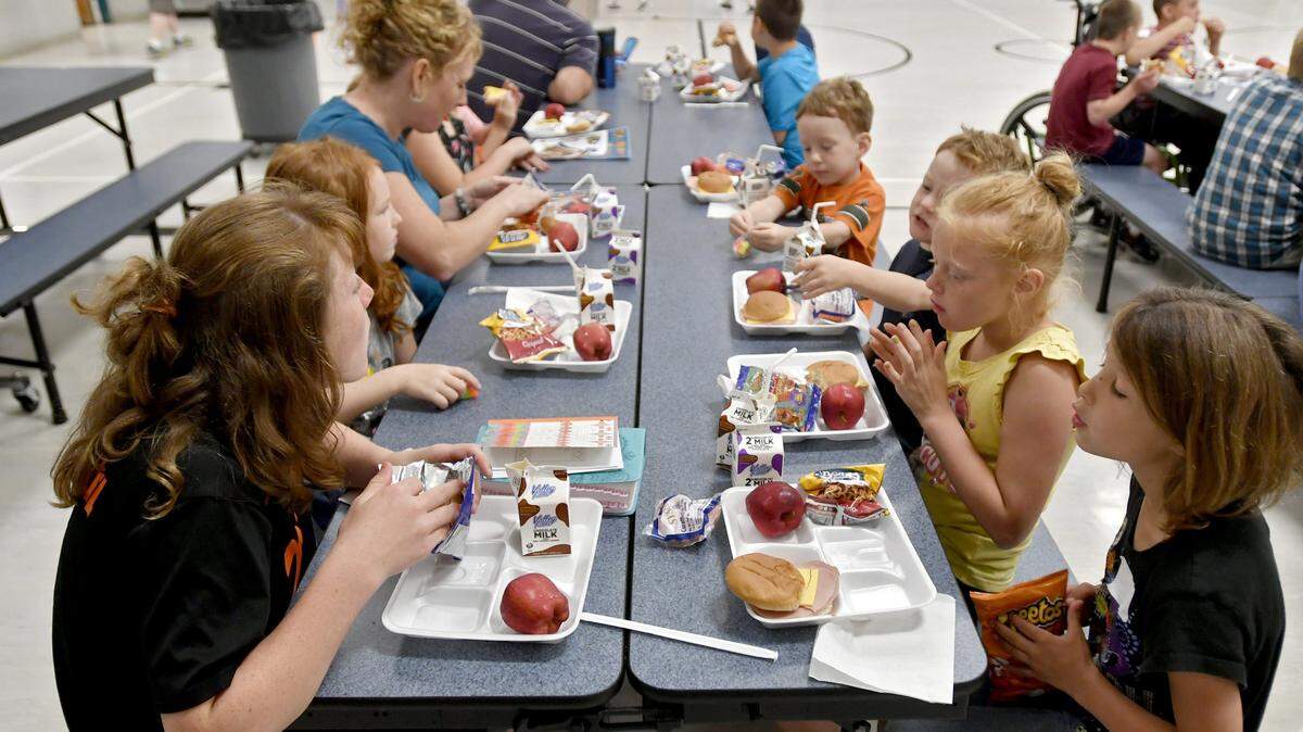 Kids enjoy milk, a ham and cheese sandwich, apples, carrots and a snack at Howard Elementary in June 2017 as part of the YMCA Summer Lunch Program.