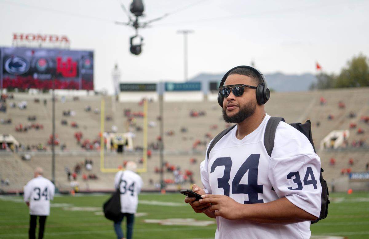 Penn State defensive tackle PJ Mustipher takes a look around the Rose Bowl stadium in a Franco Harris jersey before the game against Utah on Monday, Jan. 2, 2023. The entire Penn State football team wore Harris jerseys for their arrival.