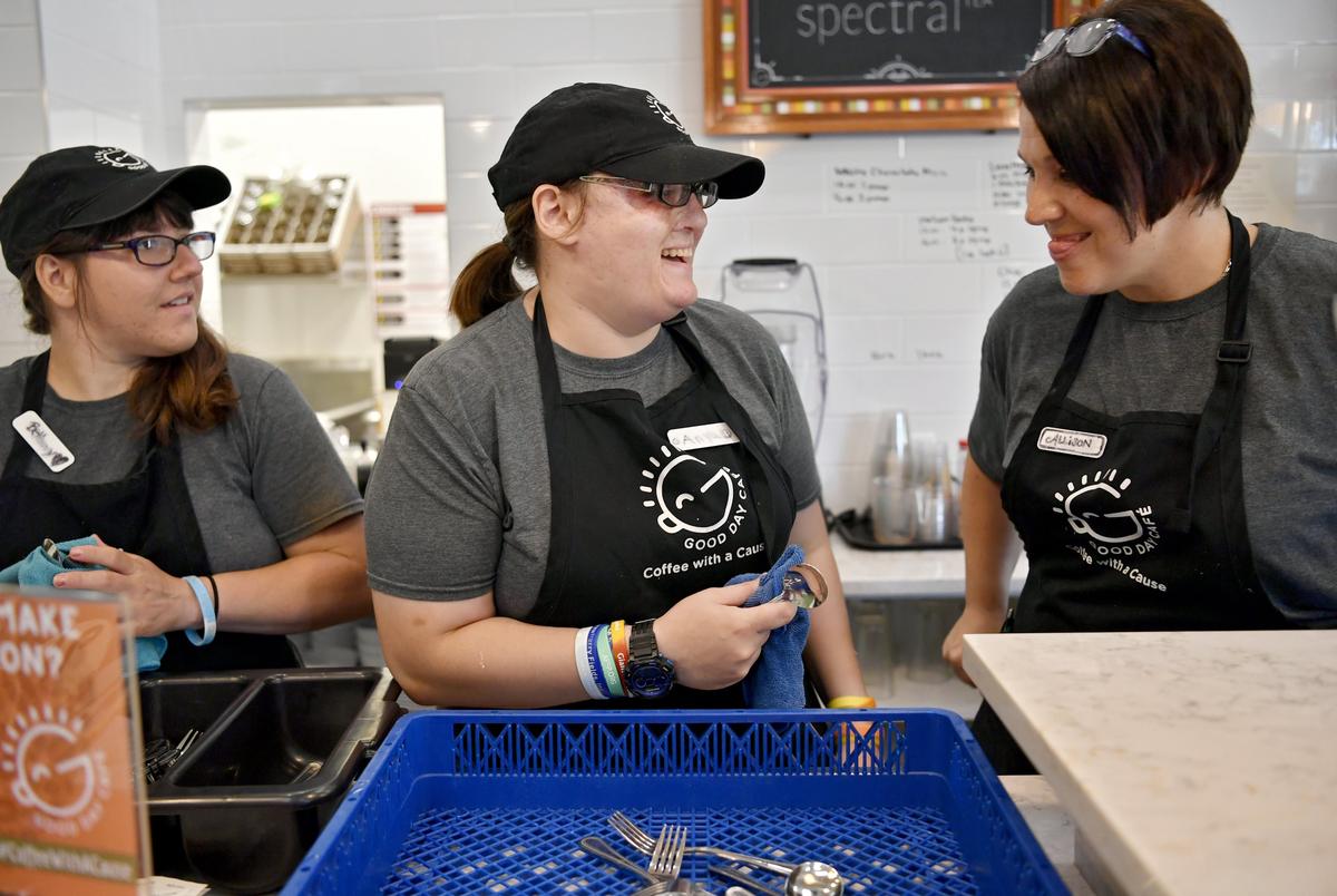 Anya Lazarow laughs with coworkers as they dry silverware at Good Day Cafe on Aug. 8.
