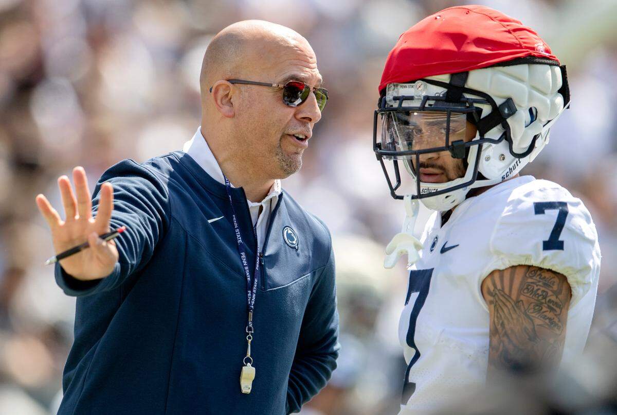 Penn State football coach James Franklin talks to wide receiver Kaden Saunders as he runs a play with special teams during the Blue-White game on Saturday, April 23, 2022.
