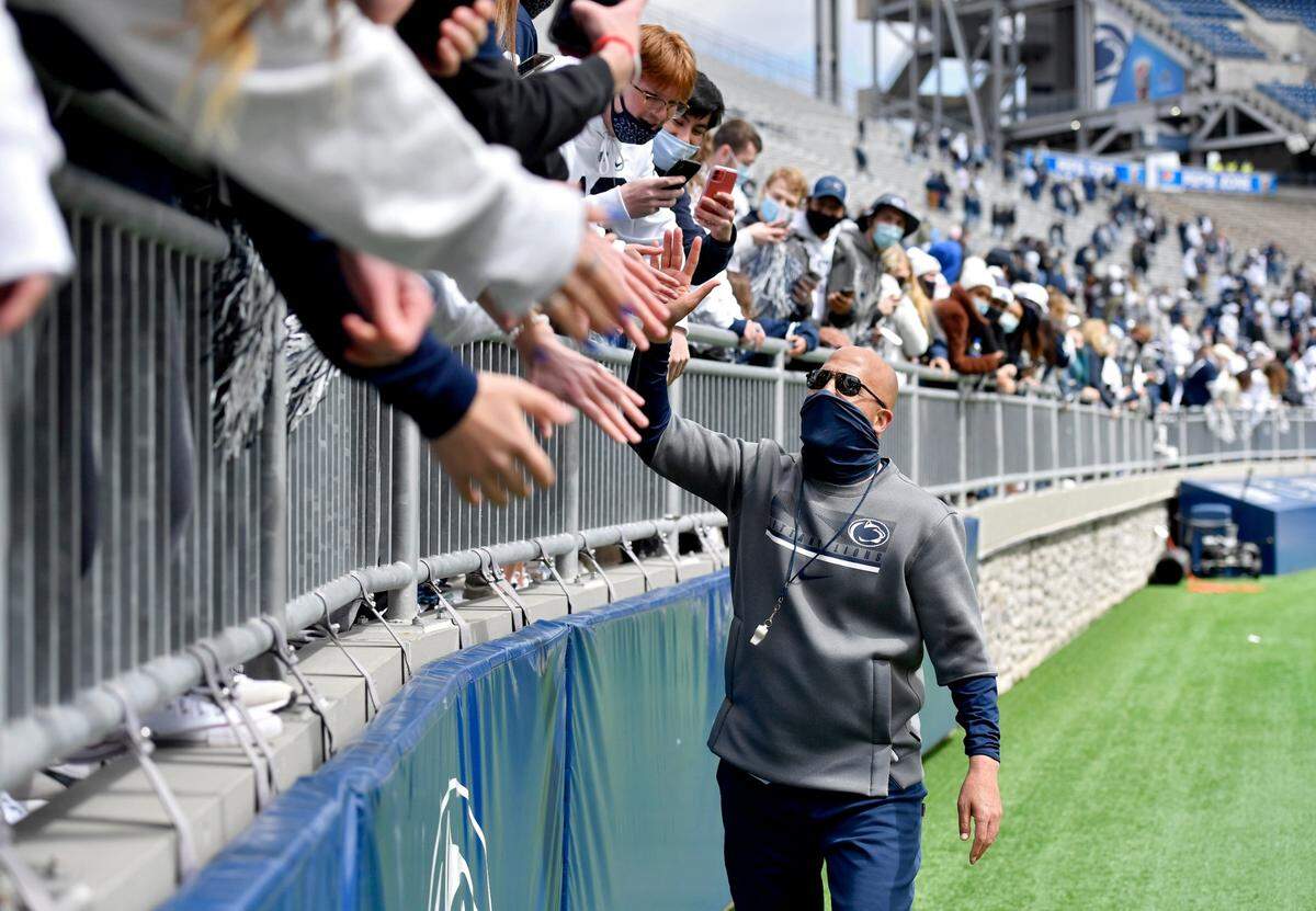 Penn State football coach James Franklin high-fives freshman fans after the spring practice on Saturday, April 17, 2021 at Beaver Stadium.