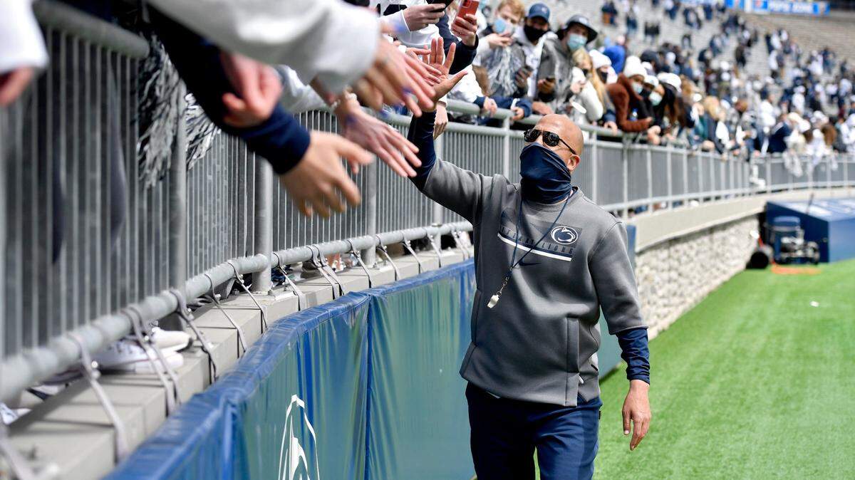 Penn State football coach James Franklin high fives freshman fans after the spring practice on Saturday, April 17, 2021 at Beaver Stadium.