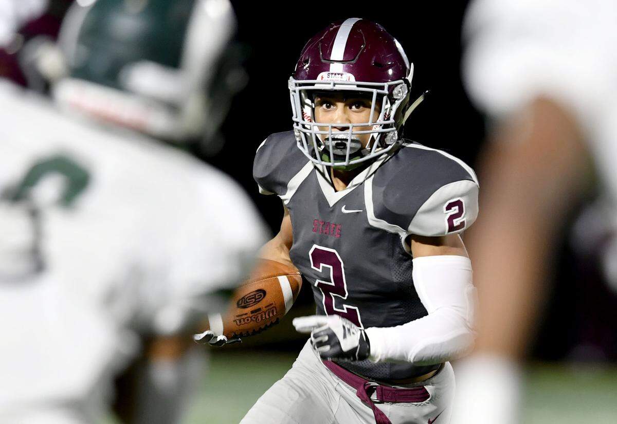 State College’s Dresyn Green runs down the field with the from Central Dauphin defenders during the game on Friday, Oct. 11, 2019.