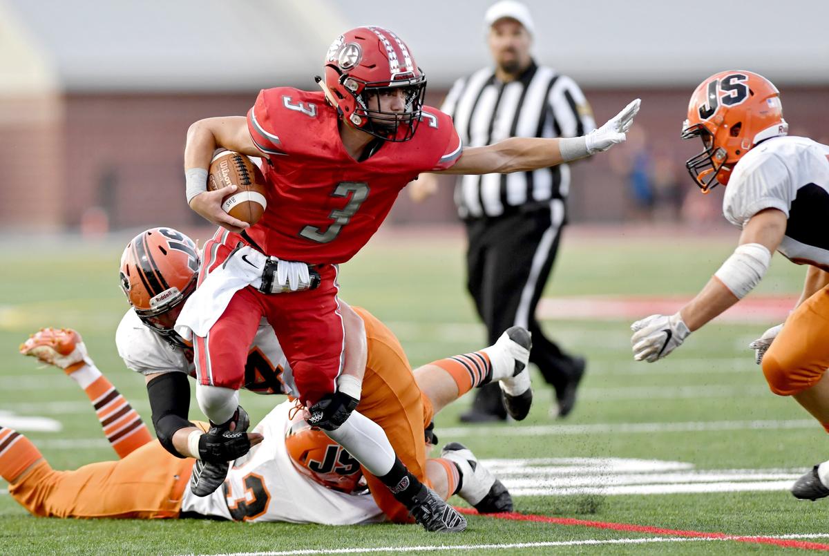 Jersey Shore tries to trip up Bellefonte’s Jalen Emel as he runs down the field with the ball during the game on Friday, August 23, 2019 at Rogers Stadium.