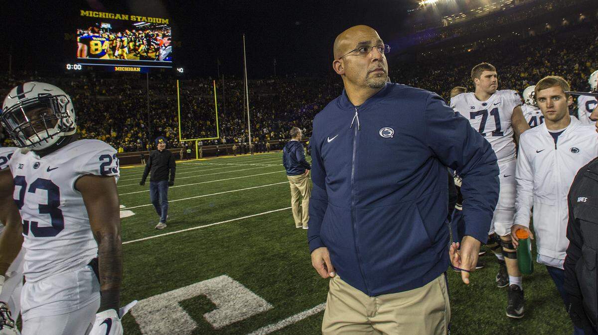 Penn State head coach James Franklin, center, walks off the Michigan Stadium field after an NCAA college football game against Michigan in Ann Arbor, Mich., Saturday, Nov. 3, 2018. Michigan won 42-7. (AP Photo/Tony Ding)