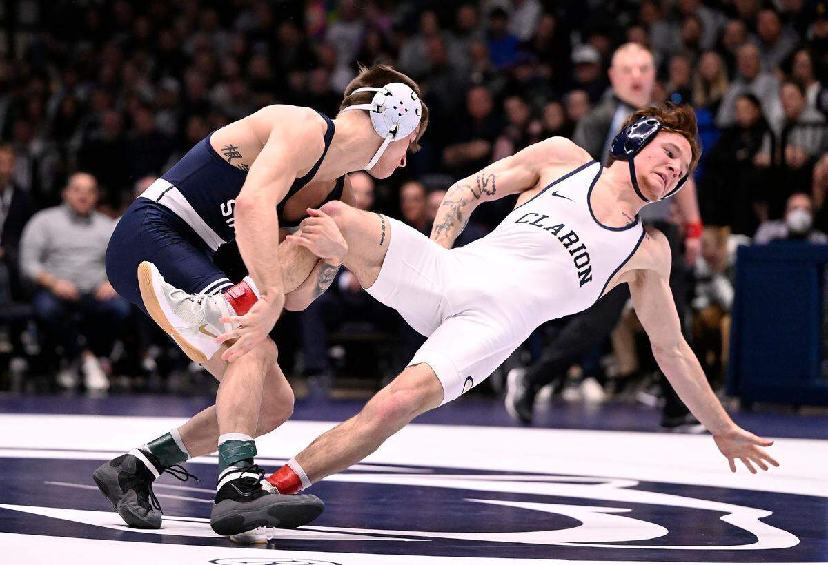Penn State’s Gary Steen (left) takes down Clarion’s Joey Fischer at 125 pounds Sunday at Rec Hall in State College. Steen won, 5-1. Penn State defeated Clarion 40-6. (For the CDT/Steve Manuel)
