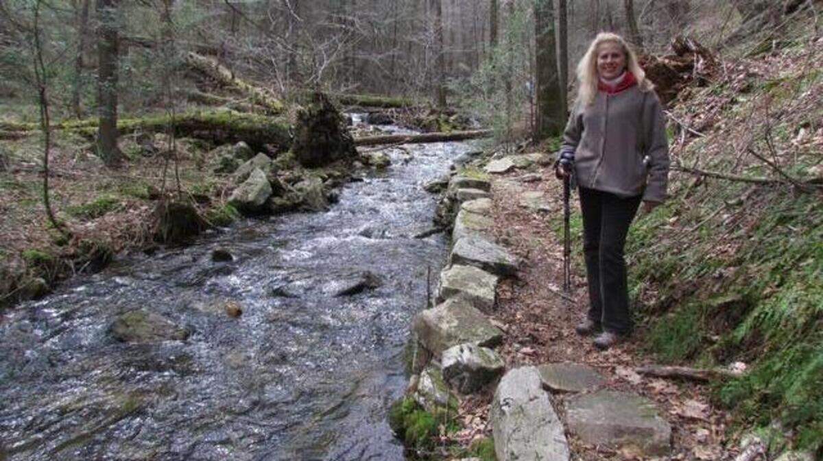 Hiker GerneyLee Carter, of State College, looks along Swift Run Trail in the Snyder-Middleswarth Natural Area.
