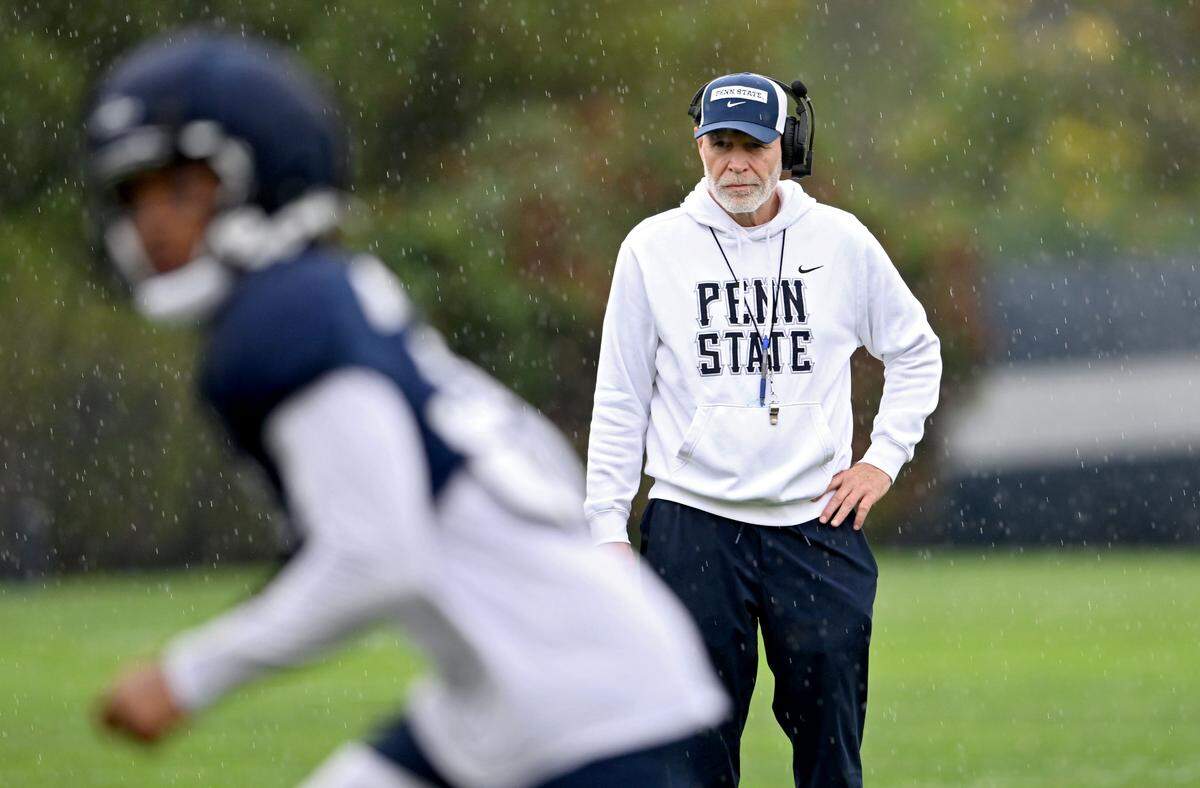 Penn State defensive coordinator Jim Knowles watches players run a drill during practice in the rain on Wednesday, Sept. 24, 2025.  