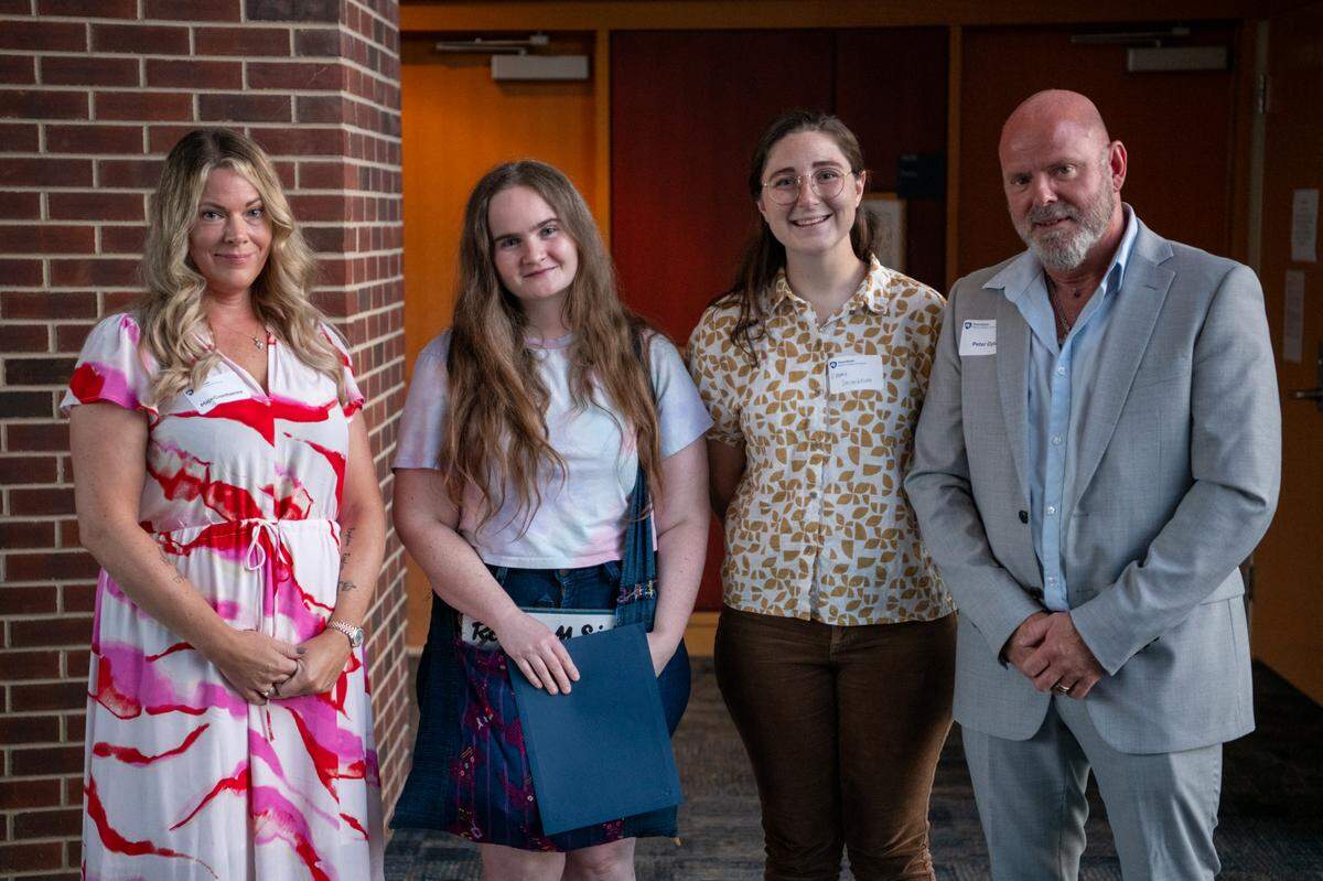 Be More Lovisa Graduate Student Scholarship recipients Šárka Blahnik (center left) and Emma Steinebronn (center right) stand with the parents of Lovisa Arnesson-Cronhamre, Maja Cronhamre (far left) and Peter Arnesson Gyld (far right).