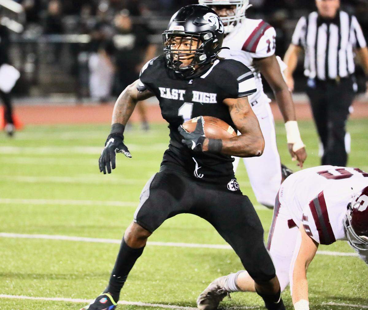 Central Dauphin East’s Mehki Flowers carries the ball against State College on Friday, Sept. 24, 2021.