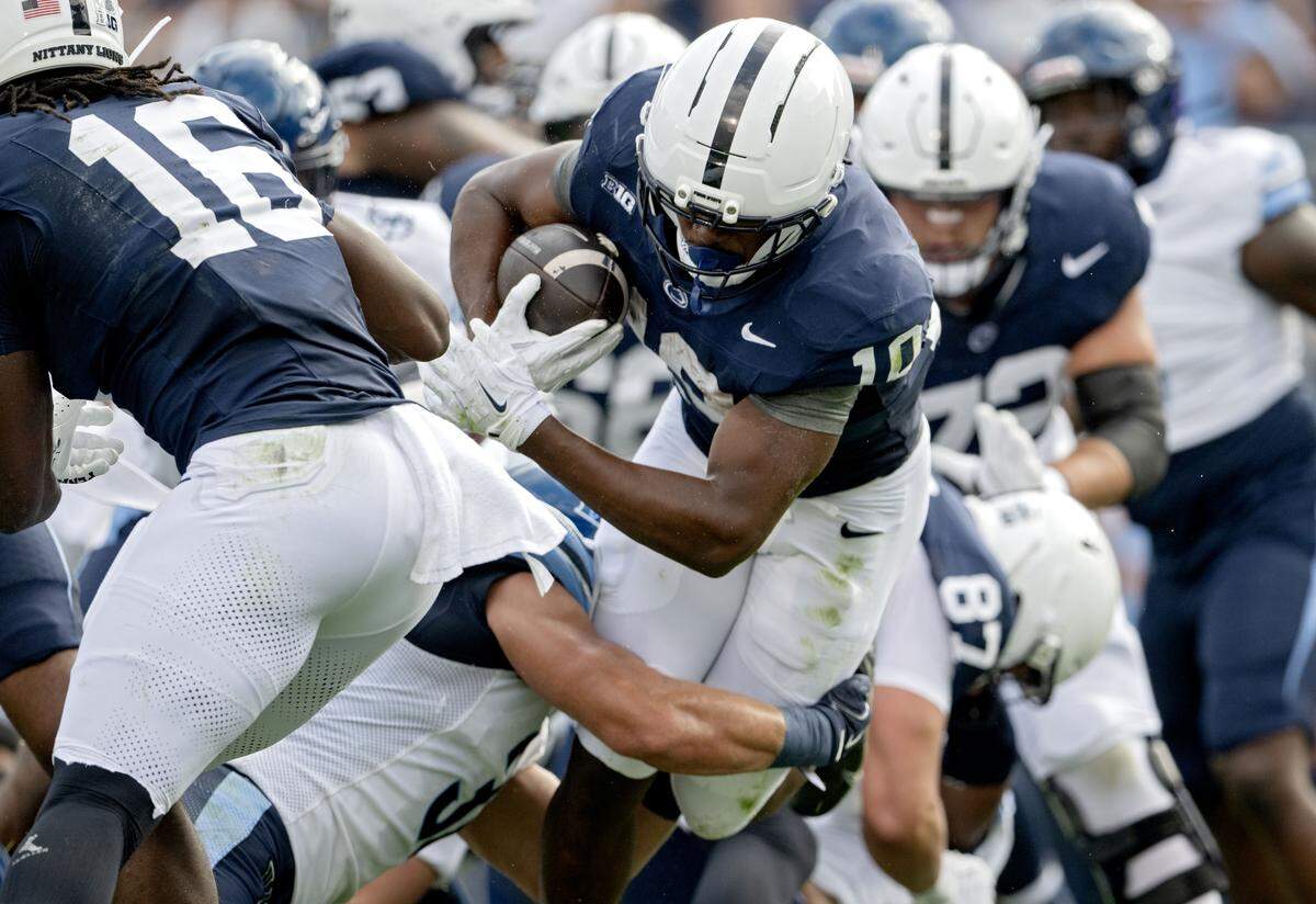 Penn State running back Nick Singleton dives into the end zone for a touchdown past Villanova defenders during the game on Saturday, Sept. 13, 2025.  