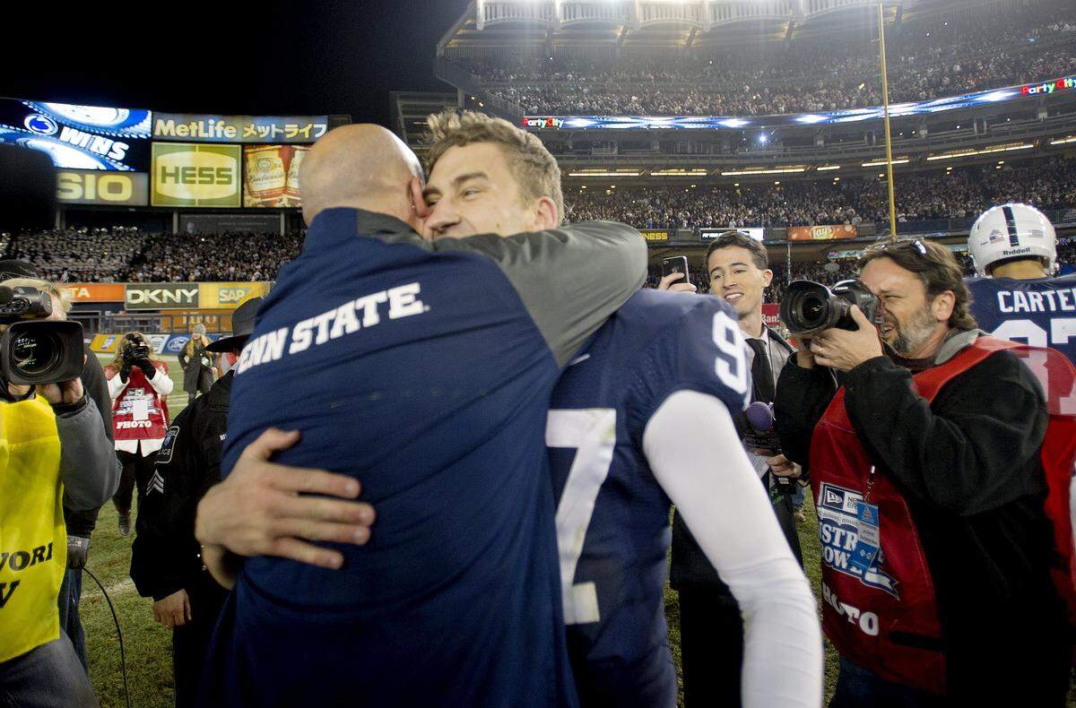 Penn State kicker Sam Ficken hugs coach James Franklin after the 31-30 overtime win over Boston College in the 2014 Pinstripe Bowl on Saturday, December 27, at Yankee Stadium.