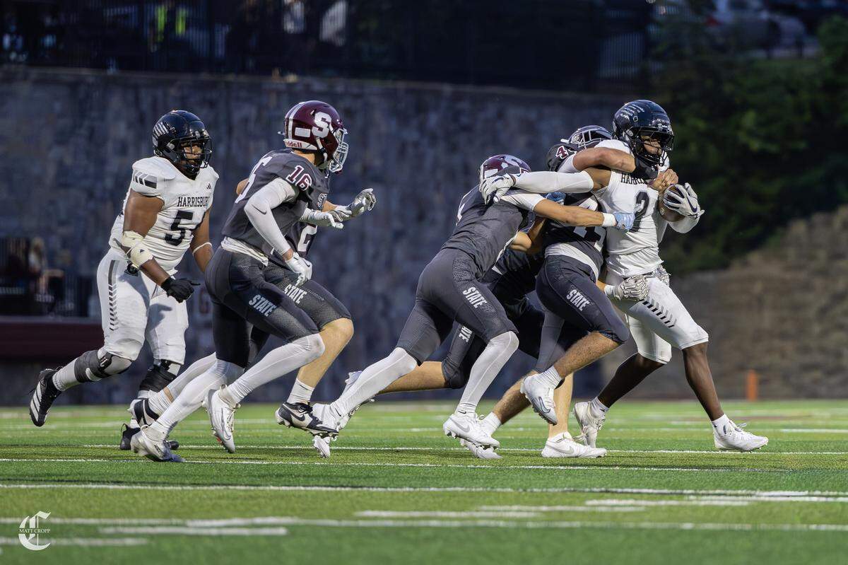 Running Back Ja'auan Johnson (3) is tackled by multiple players on Friday, Sept. 5, 2025 in State College, Pa. The Little Lions beat the Cougars 48-45.